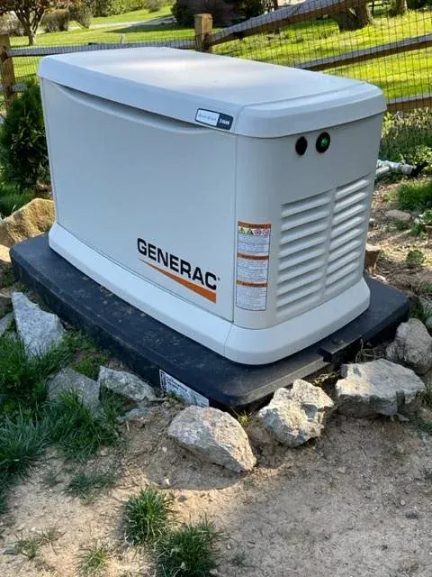 Generac standby generator on its pad in a backyard, ready for an electrical check