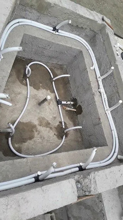 Electrical conduit runs set in a concrete pool shell during construction
